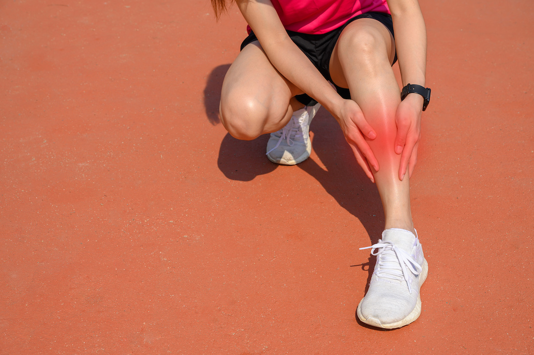 Cropped shot of woman runner suffering pain from Shin splint. It often happens in the front or inside of the lower leg from overtraining. Conceptual of common running injuries. Cropped shot of woman runner suffering pain from Shin splint. It often happens in the front or inside of the lower leg from overtraining. Conceptual of common running injuries.